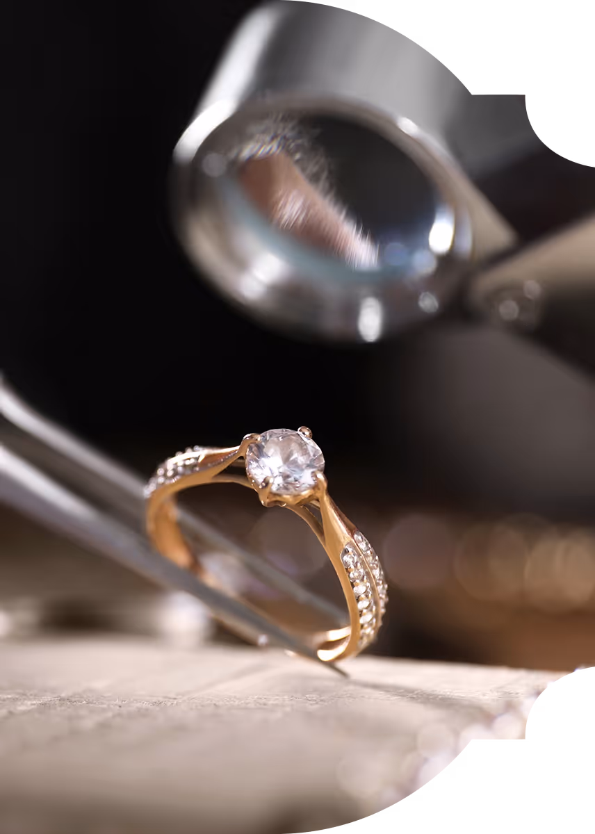 Jeweler examining a diamond ring through a loupe
